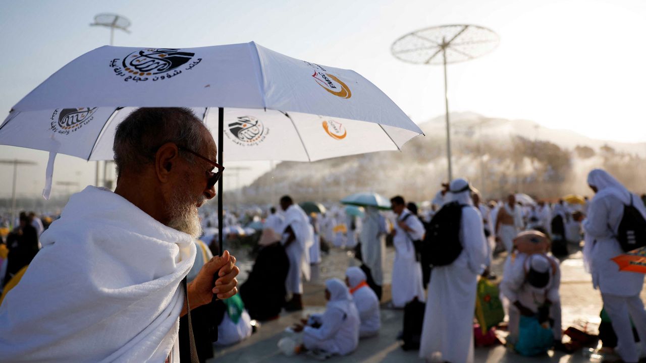 Muslim pilgrims hold umbrellas to shield from the glaring sun as they gather on the plain of Arafat during Hajj on June 15.