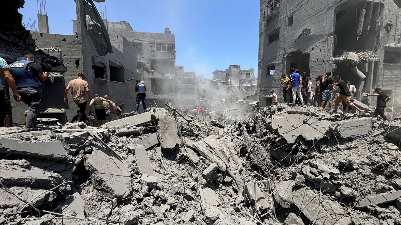 Palestinians search for casualties at the site of Israeli strikes on houses, amid Israel-Hamas conflict, in Gaza City, June 22, 2024.