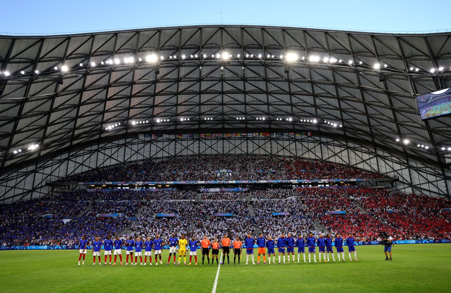 Soccer players from France and the United States line up before the start of their match on Wednesday, July 24.