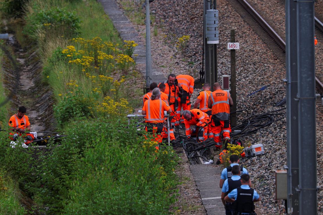 Railway staff and police work to repair one of several sites where vandals targeted France's high-speed train network, in the northern villege of Croisilles, on Friday.