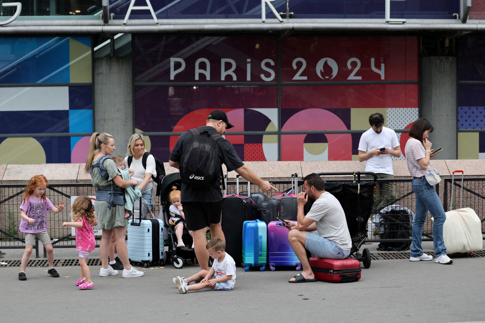 Travellers from Sydney wait outside the Gare Montparnasse train station on July 26. Just hours before the opening ceremony, <a href="https://www.cnn.com/sport/live-news/paris-olympics-2024-opening-ceremony-seine#h_3e01b5ed3f2771f05d04f206fbffd246">France’s high-speed train lines were targeted by several “malicious” acts</a>, including arson, in what has been described as “coordinated sabotage” to disrupt travel ahead of the Games.