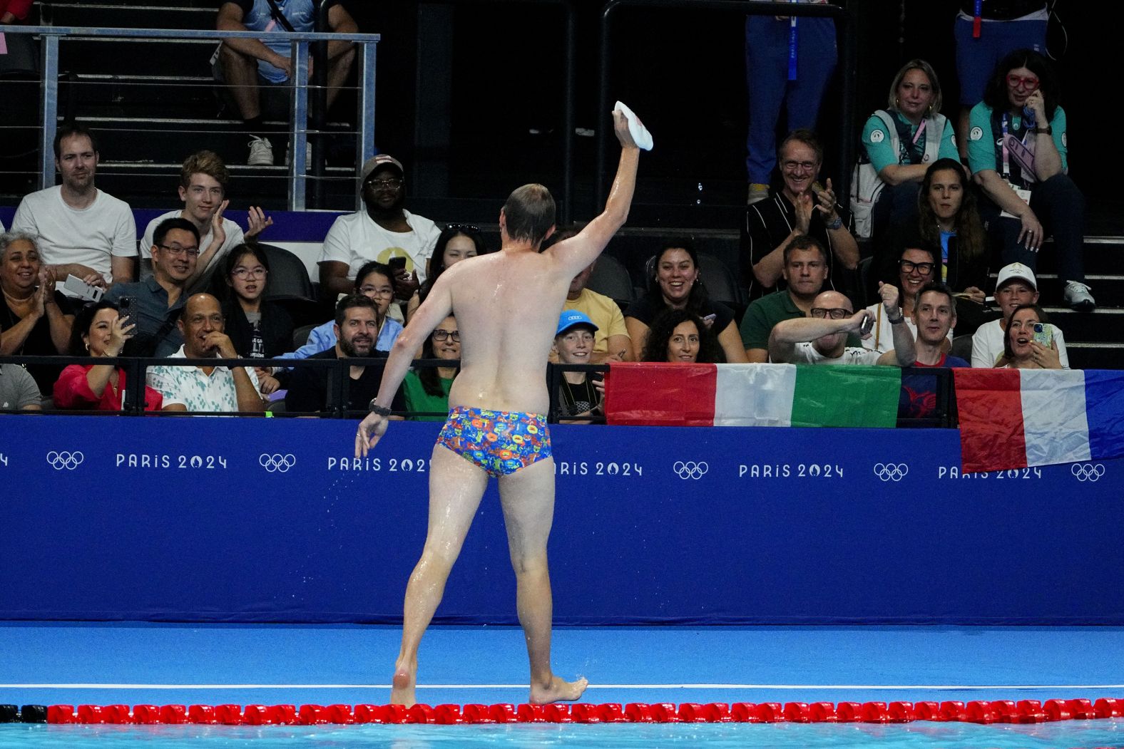 The crowd cheers for a lifeguard after he went into the pool to recover the swim cap of US swimmer Emma Weber on July 28. Lifeguards like this are common at swimming competitions, but it still provided a moment of levity in between races. <a href="https://www.cnn.com/2024/07/28/sport/olympic-moment-lifeguard-swimming-spt-intl/index.html">NBC's commentary crew deemed him “Bob the Cap Catcher.”</a> The lifeguard declined to release his name, a Paris 2024 spokesperson said, so that he could keep the focus on his duties.