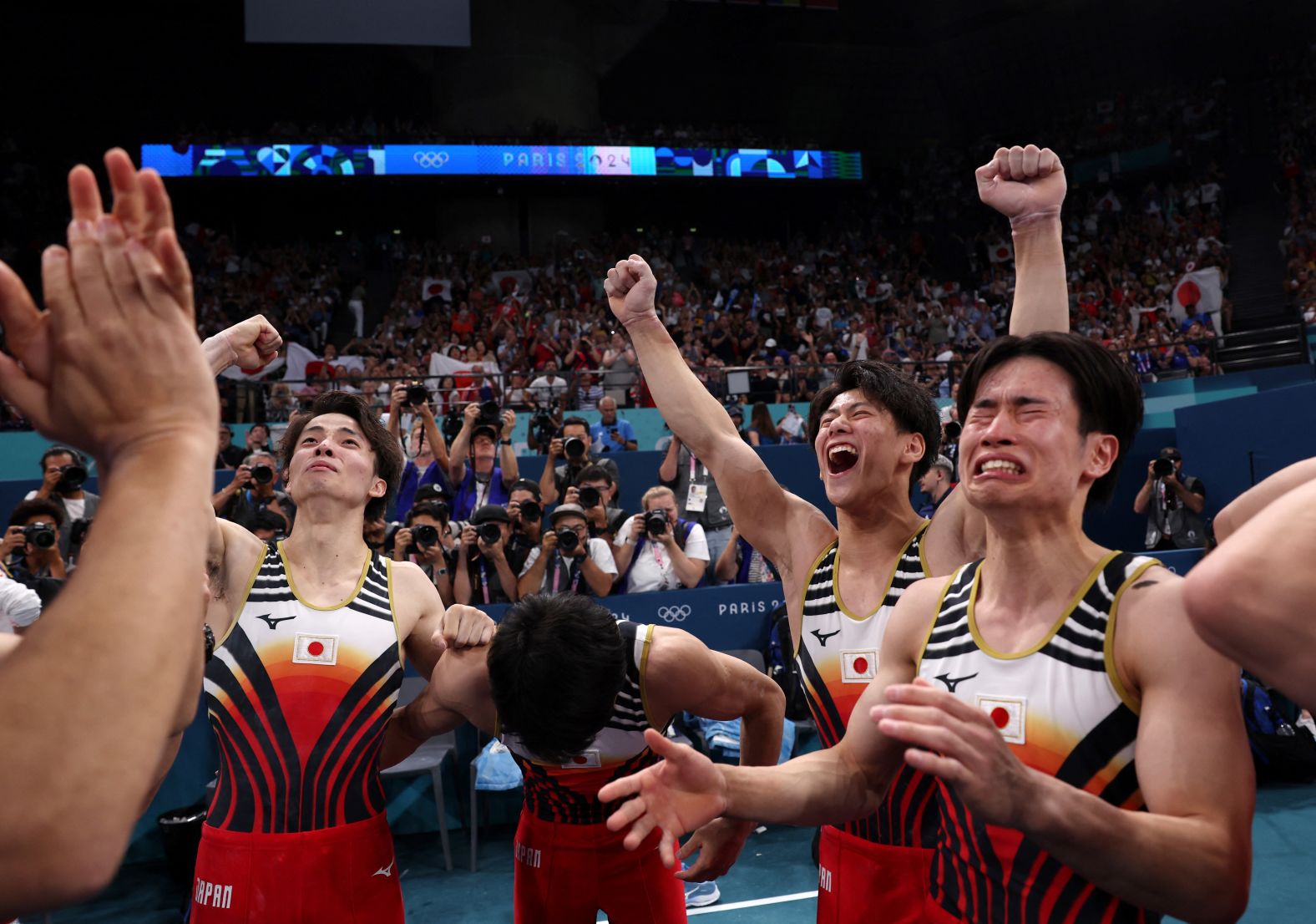 Japanese gymnasts celebrate after they won gold in the team competition on July 29. The Chinese team was in first place heading into the final rotation, but <a href="https://www.cnn.com/sport/live-news/paris-olympics-news-2024-07-29#h_1d07bdf444f6d54879d7e0119876b3b4">some costly mistakes on the horizontal bar</a> dropped it to second place. The United States won the bronze.