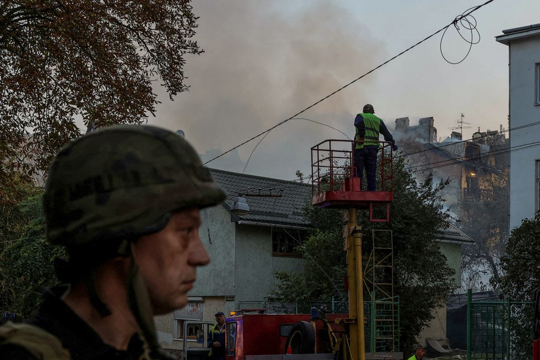 Municipal workers check power lines at a site of a residential building damaged during a Russian drone and missile strike, amid Russia's attack on Ukraine, in Lviv, Ukraine on September 4, 2024.