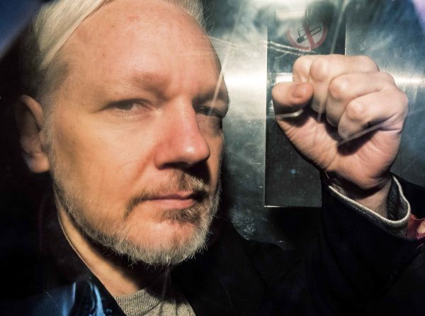 Assange is seen through the window of a prison van as he is driven into the Southwark Crown Court in London in May 2019. He was sentenced to 50 weeks in prison for breaching his bail conditions in 2012.