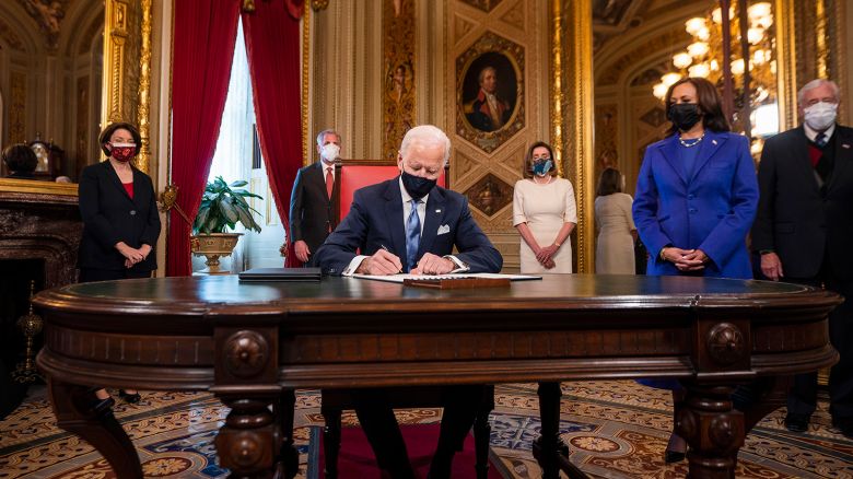 President Joe Biden signs three documents including an inauguration declaration, cabinet nominations and sub-cabinet nominations in the President's Room at the US Capitol after the inauguration ceremony, Wednesday, Jan. 20, 2021, at the U.S. Capitol in Washington. Vice President Kamala Harris watches at right. (Jim Lo Scalzo/Pool Photo via AP)