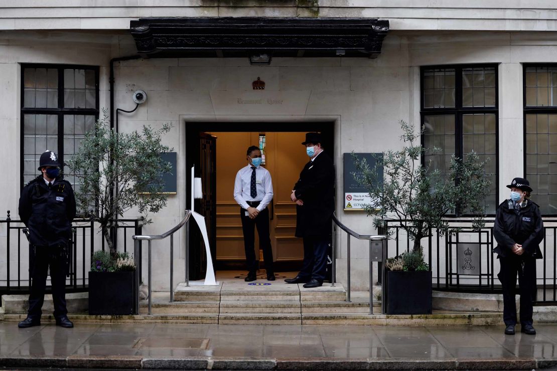 Police stand guard outside London's King Edward VII hospital where Prince Philip was admitted on Tuesday evening.