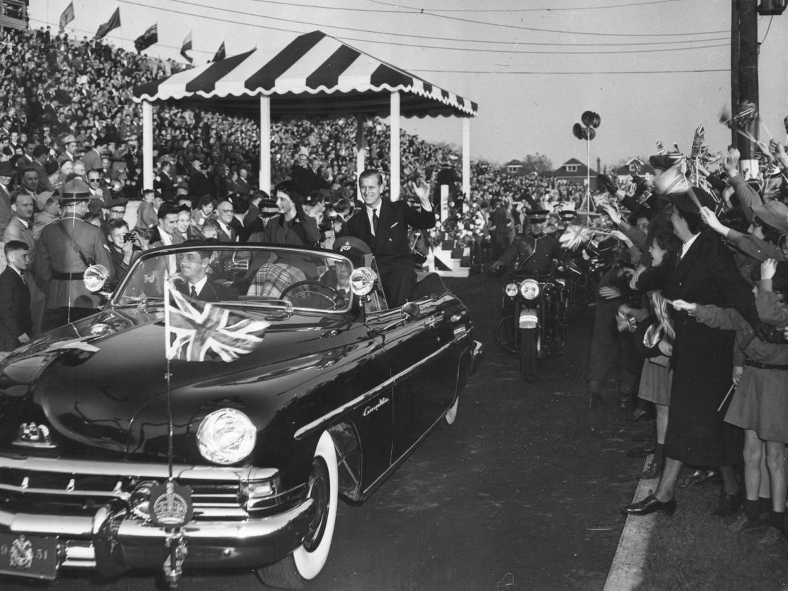 Princess Elizabeth and the Duke of Edinburgh greet a crowd during their tour of Hamilton, Canada in 1951.