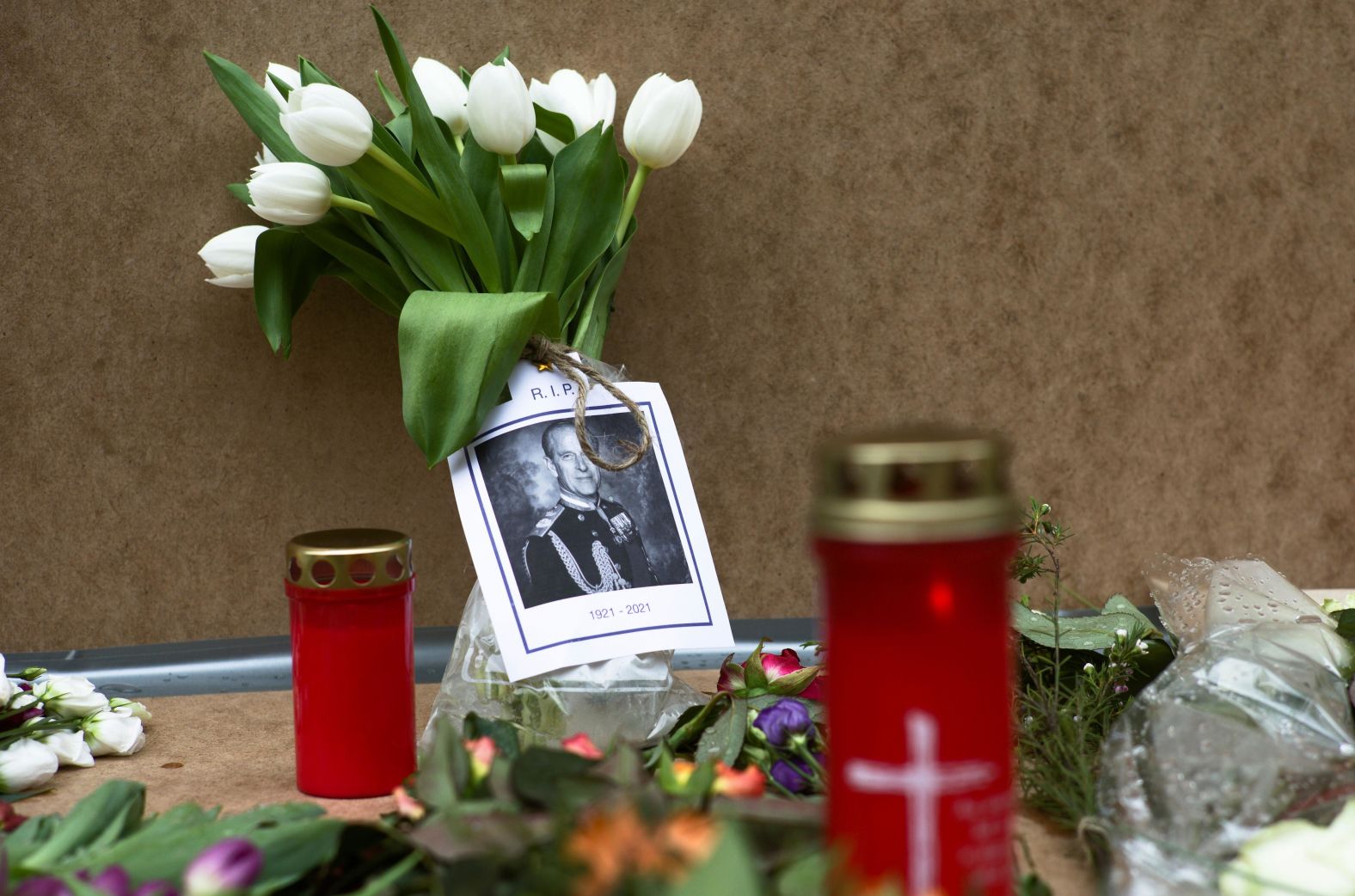 A portrait of Prince Philip is placed with flowers and candles in front of the British Embassy in Berlin.