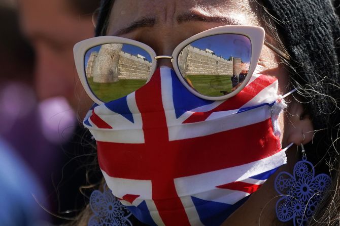 A woman looks toward Windsor Castle and St George's Chapel during the funeral of Prince Philip.