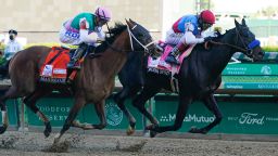 John Velazquez, right, rides Medina Spirit ahead of Florent Geroux aboard Mandaloun to win the 147th running of the Kentucky Derby at Churchill Downs, Saturday, May 1, 2021, in Louisville, Ky. (AP Photo/Darron Cummings)