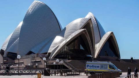 A police vehicle is seen near Sydney Opera House in Sydney, Australia, July 18, 2021. Rising COVID-19 cases sparked tougher restrictions with more retail closed in Australia's state of New South Wales NSW, the epicenter of the country's current outbreak, on Saturday. (Photo by Bai Xuefei/Xinhua via Getty Images)