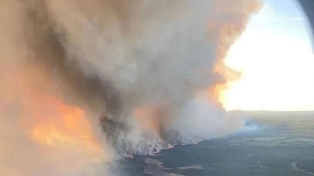 This handout courtesy of the British Columbia Wildfire Service, taken May 10, 2024, shows the Parker Lake wildfire seen through an airplane window as it burns near Fort Nelson in British Columbia, Canada.