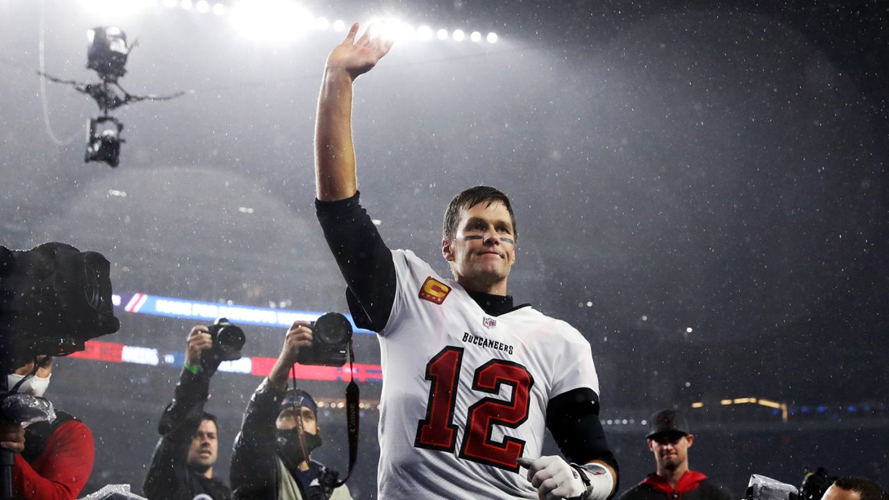 FOXBOROUGH, MASSACHUSETTS - OCTOBER 03: Tom Brady #12 of the Tampa Bay Buccaneers waves to the crowd as he runs off the field after defeating the New England Patriots in the game at Gillette Stadium on October 03, 2021 in Foxborough, Massachusetts. (Photo by Maddie Meyer/Getty Images)