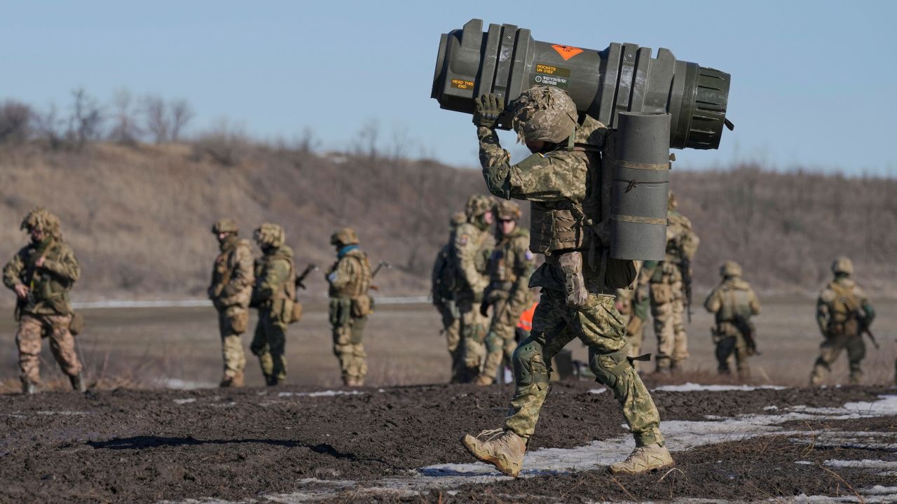 FILE - A Ukrainian serviceman carries an NLAW anti-tank weapon during an exercise in the Joint Forces Operation, in the Donetsk region, eastern Ukraine, Feb. 15, 2022. As the U.S. and other NATO members warn of the potential for a devastating war, Russia is not countering with bombs or olive branches -- but with sarcasm. (AP Photo/Vadim Ghirda, File)
