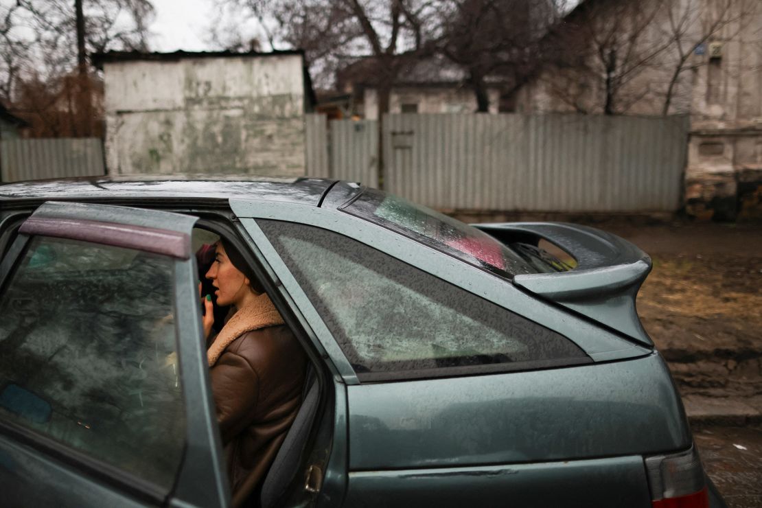 A local resident sits in a car as they pack to leave Mariupol, eastern Ukraine.