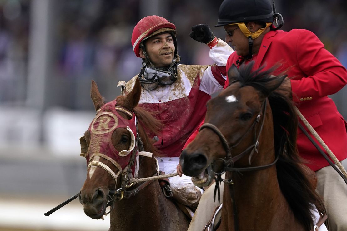 Sonny Leon celebrates after riding Rich Strike past the finish line. 