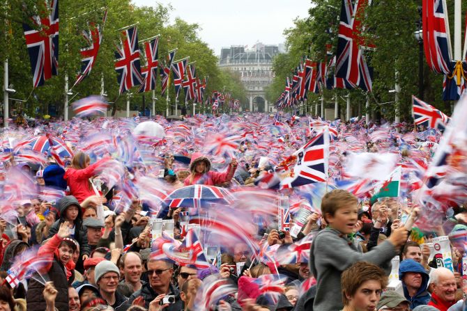 The Mall is awash with red, white and blue as revelers pack in to watch the royal family take to the Buckingham Palace balcony.