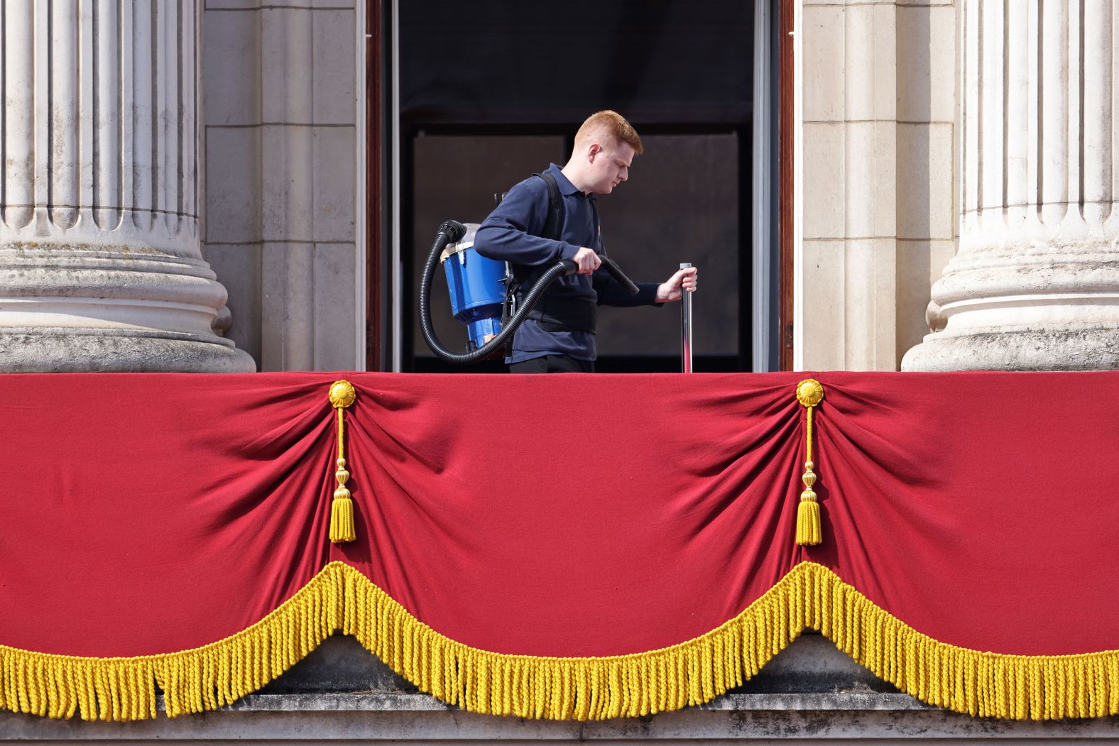 A member of the Buckingham Palace staff cleans the balcony ahead of the Trooping the Colour parade on Thursday.