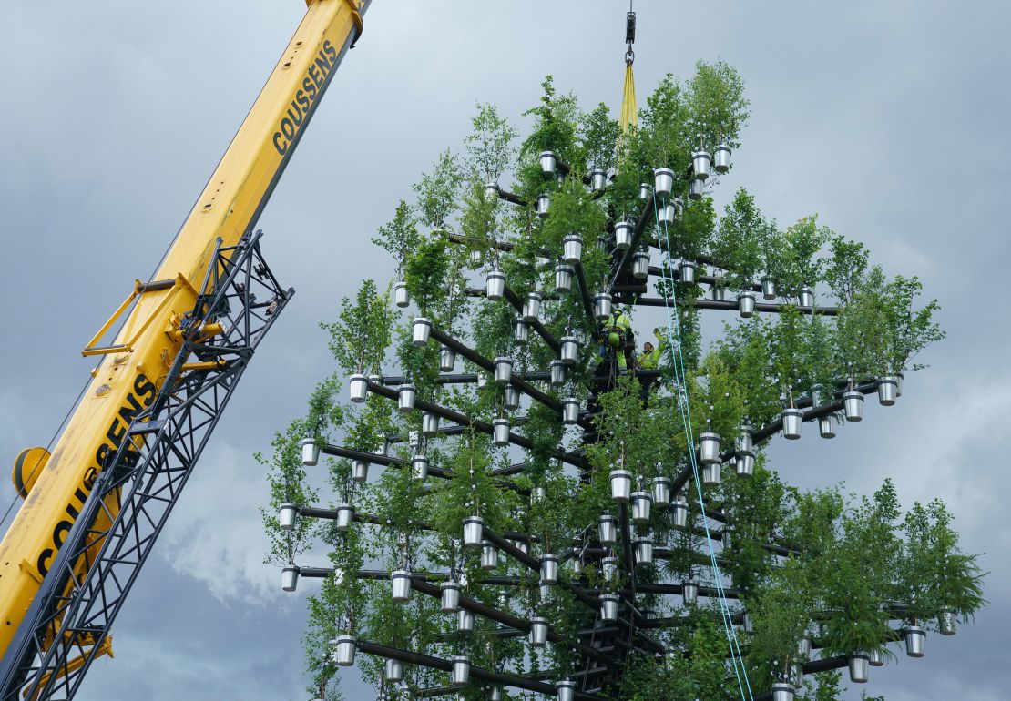 A team of workers add the final parts to the "Tree of Trees." The sculpture which will stand outside Buckingham Palace for the duration of the Queen's Platinum Jubilee celebrations in June.