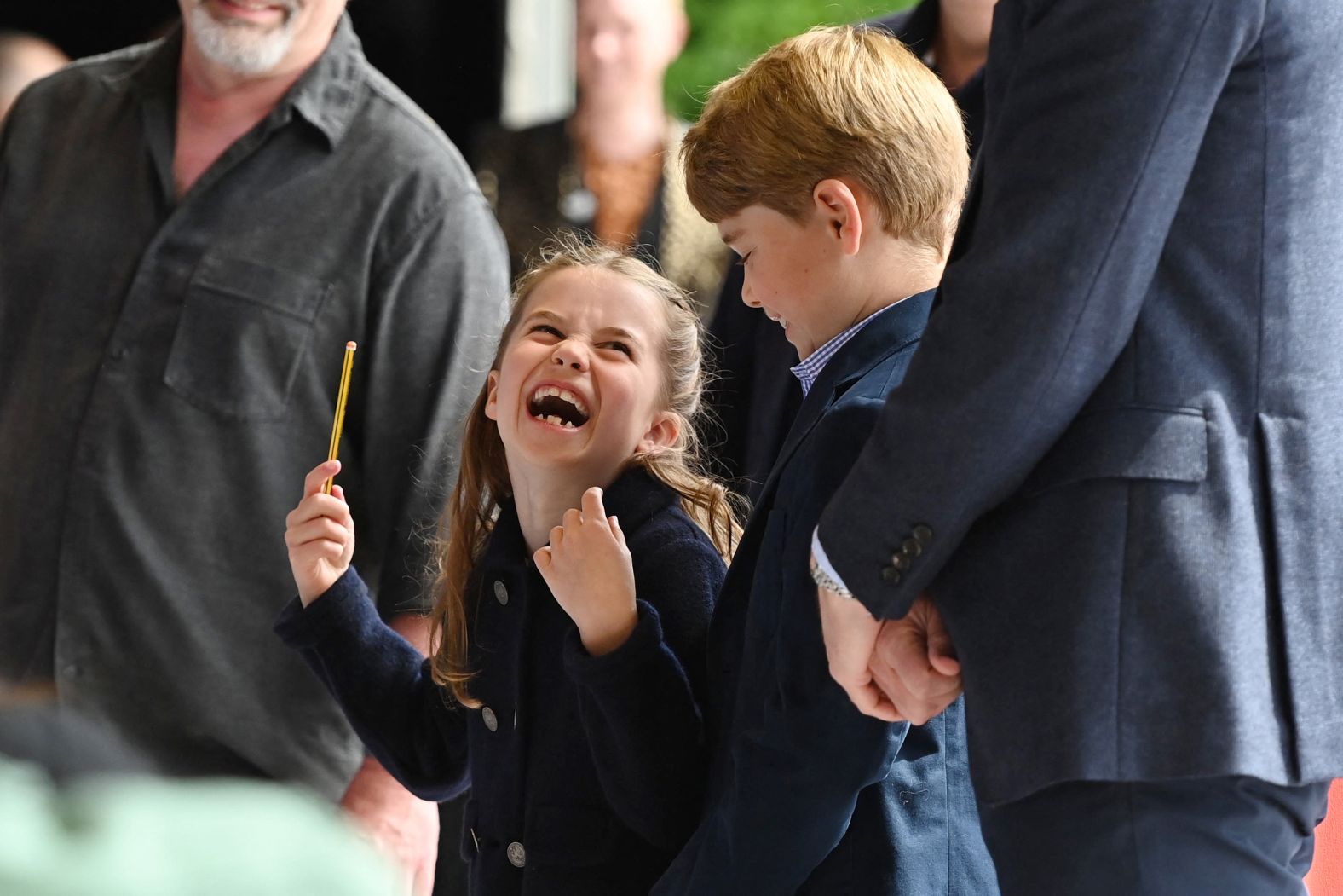 Princess Charlotte conducts a band next to her brother Prince George as they visited Cardiff Castle in Wales.