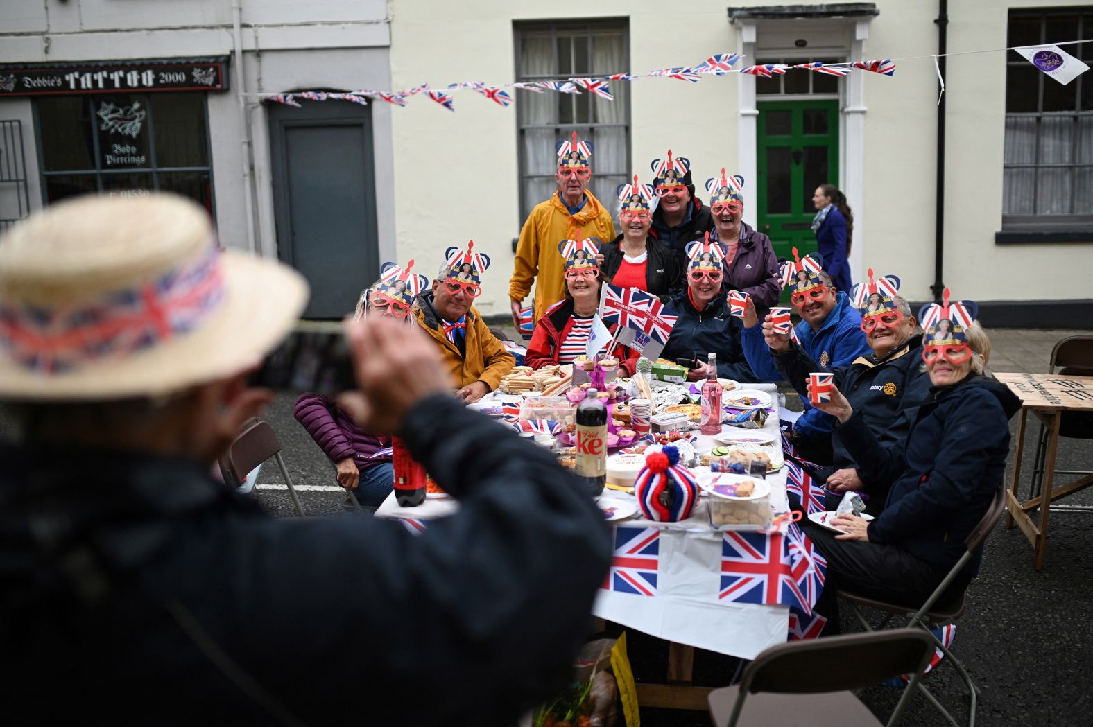 Revelers pose for pictures as they attend a party in Ashby-de-la-Zouch, England, on Sunday.