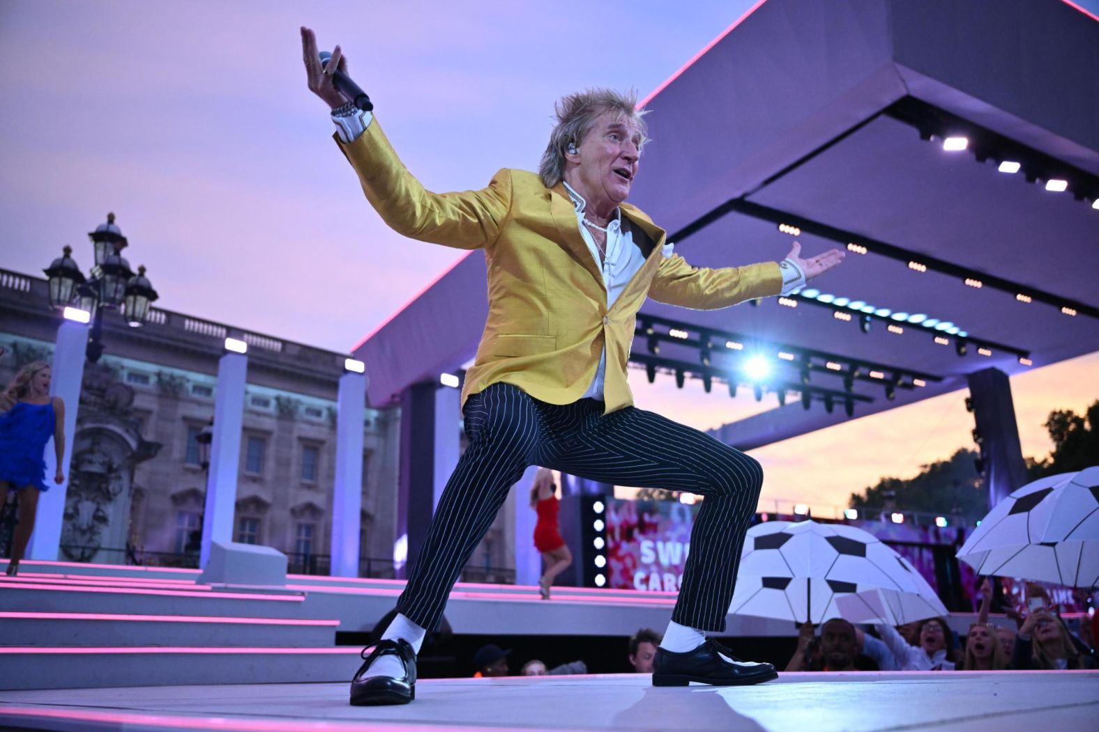 Rod Stewart performs on stage during Saturday night's concert, where he performed Neil Diamond's "Sweet Caroline," a British karaoke classic.