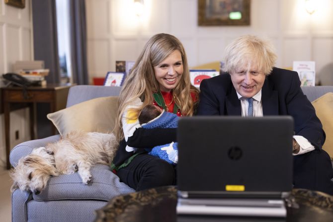 Johnson and his wife, Carrie, holding their newborn daughter, Romy, hold video calls in December 2021.