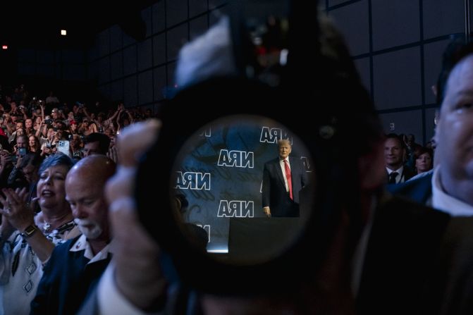 Trump is seen in the reflection of a camera lens as he appears at the National Rifle Association's annual convention in May 2022. Trump — and other GOP leaders who spoke at the event in Houston — <a href="https://www.cnn.com/2022/05/27/politics/uvalde-donald-trump-nra-convention/index.html" target="_blank">rejected efforts to overhaul gun laws,</a> and they mocked Democrats and activists calling for change.