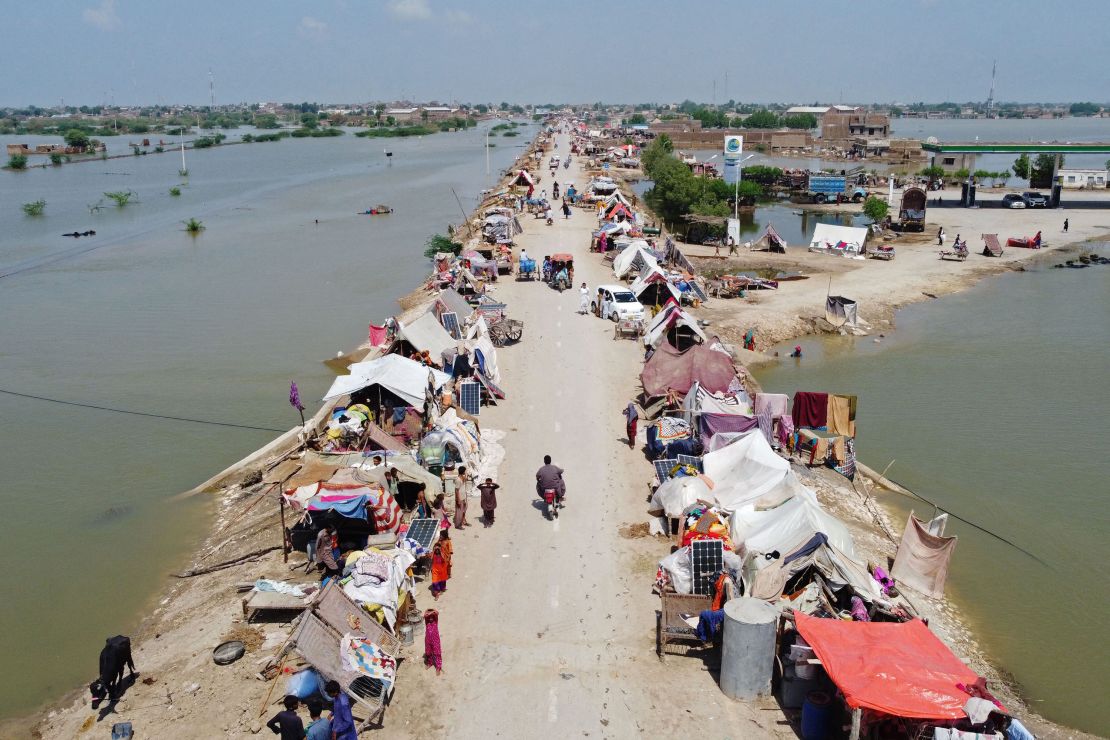 People in Pakistan take refuge from flooding in a makeshift camp on August 31 in the Jaffarabad district of Balochistan province.