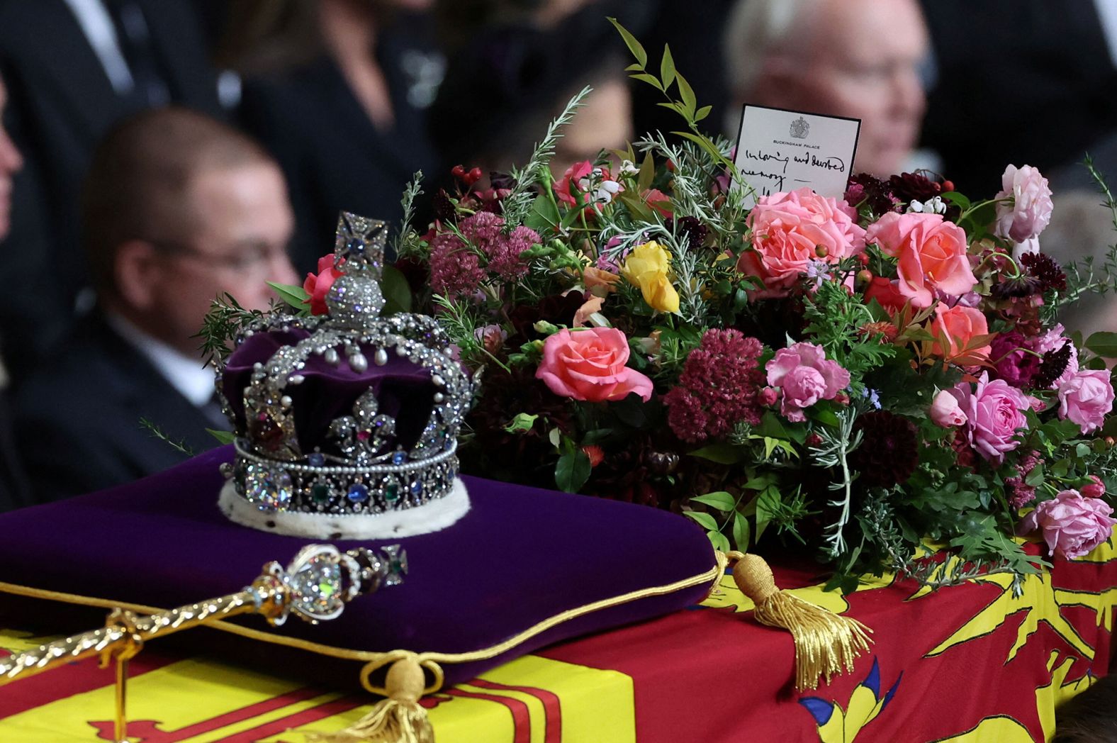 <a href="https://www.cnn.com/2022/09/19/europe/queen-funeral-coffin-note-charles-gbr-intl-scli/index.html" target="_blank">A handwritten card</a> placed on top of the Queen's coffin reads, "In loving and devoted memory. Charles R." The "R" in King Charles' title refers to "Rex," which is Latin for king.