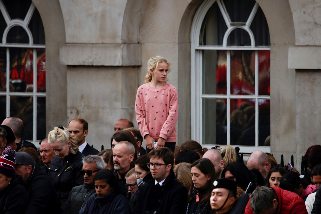 Mourners observe two minutes of silence outside Buckingham Palace.