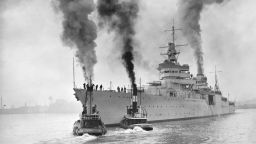 (Original Caption) USS Indianapolis. On Approval! Camden, N.J.: The United States Cruiser Indianapolis is nosed out of Camden N.J. by powerful tugs, and speeded on her way to Rockland, Maine. The new seafighter will put through her paces during the trial cruise. If she meets with government requirements on the trip she will be accepted by Uncle Sam and put into commission.