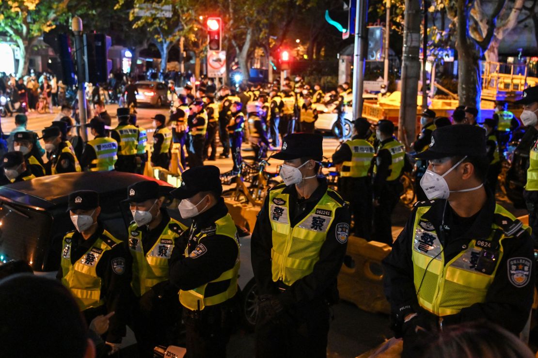 Police officers block Shanghai's Urumqi Road on Sunday.