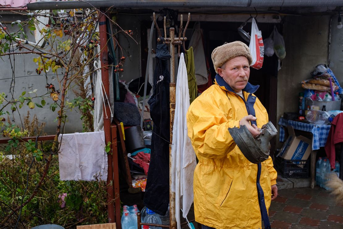 Valeriy shows a piece of the Russian shell that landed in his yard.