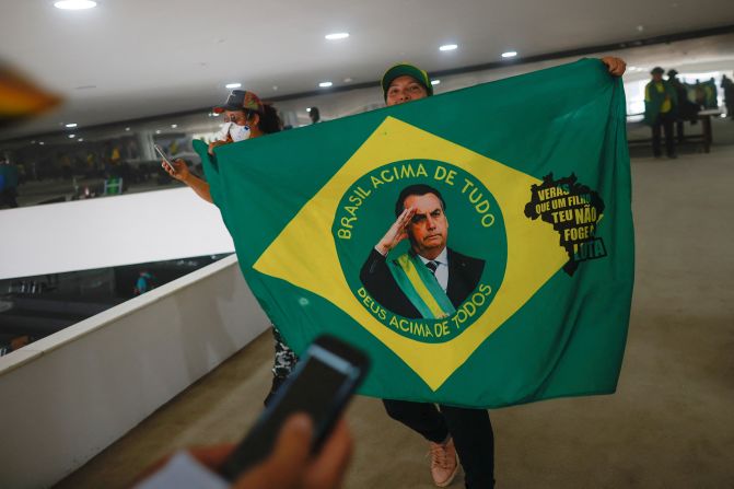 A supporter of Brazil's former President Jair Bolsonaro holds a flag depicting him during a demonstration against President Luiz Inacio Lula da Silva, in Brasilia.