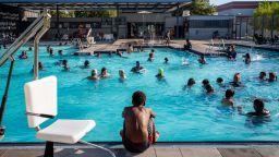 HOUSTON, TEXAS - JULY 19: A child watches others swim at the Emancipation Swimming Pool on July 19, 2022 in Houston City. The National Weather service has issued an excessive heat warning across Texas this week with predicted highs ranging from 102 degrees F in Houston to 112 degrees Fin Dallas-Fort Worth, while temperature highs in the South Plains are expected to fall somewhere between. (Photo by Brandon Bell/Getty Images)