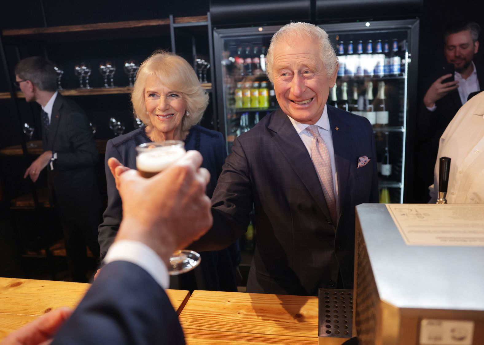 The King and Queen Consort make a toast at their final reception in Hamburg.