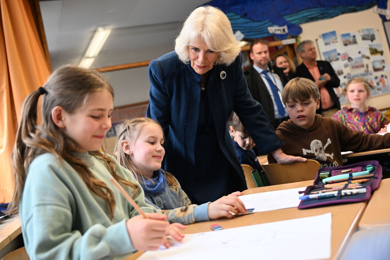 The Queen Consort talks to children during a visit to the Rudolf Ross Grundschule School in Hamburg.