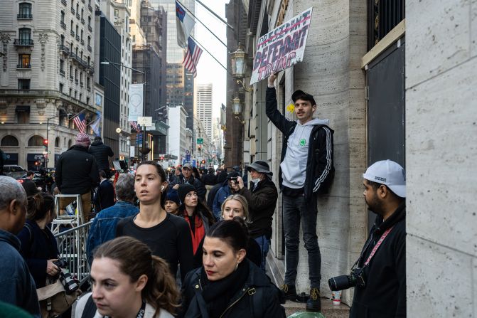 A protester holds a sign outside Trump Tower on April 4, 2023.