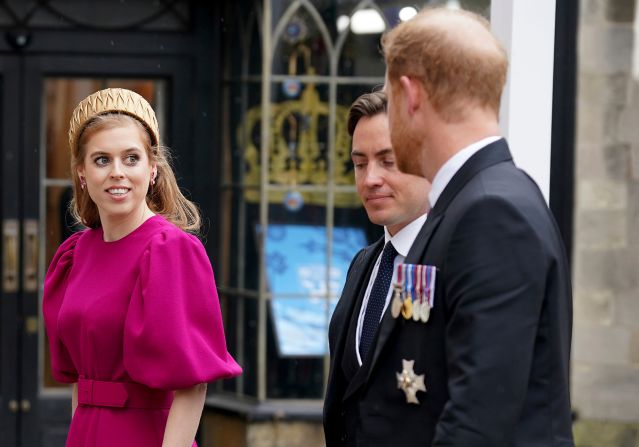 Prince Harry, right, arrives at Westminster Abbey along with Princess Beatrice, one of the King's nieces, and her husband, Edoardo Mapelli Mozzi.  <a href="https://www.cnn.com/uk/live-news/king-charles-iii-coronation-ckc-intl-gbr/h_d46a1c2f25cd5c5ed888c323a5411ae9" target="_blank">Harry accepted the invitation to his father's coronation</a> but was without his wife, Meghan, who stayed back in California with the couple's two children.