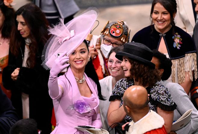 Singer Katy Perry takes a selfie with guests at Westminster Abbey. The coronation guests included <a href="https://www.cnn.com/uk/live-news/king-charles-iii-coronation-ckc-intl-gbr/h_6381e2bc126c139f48714994a44b7510" target="_blank">celebrities and world leaders</a>.