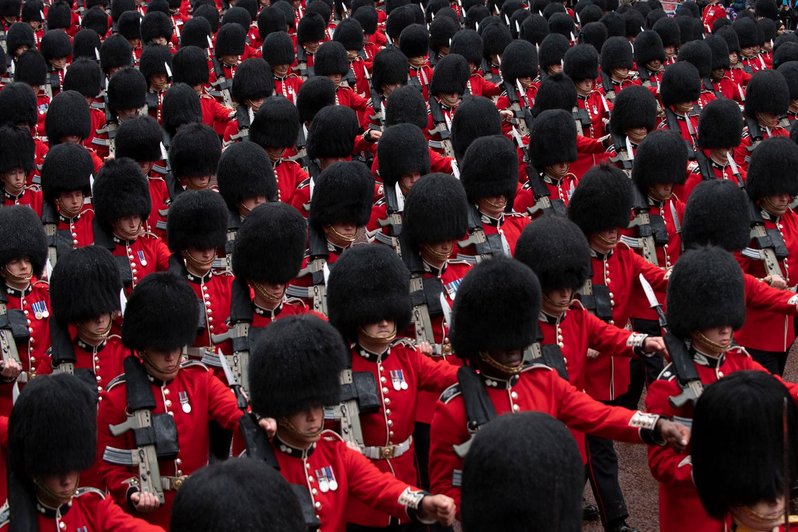 Troops march in London for the King's coronation. On their way back to Buckingham Palace, the King and Queen were accompanied by a huge parade of soldiers, musicians and horses.