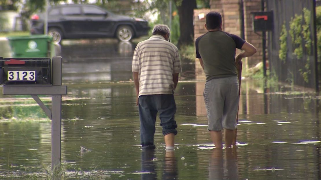 People wade through floodwaters in Houston, Texas, on May 9, 2024.