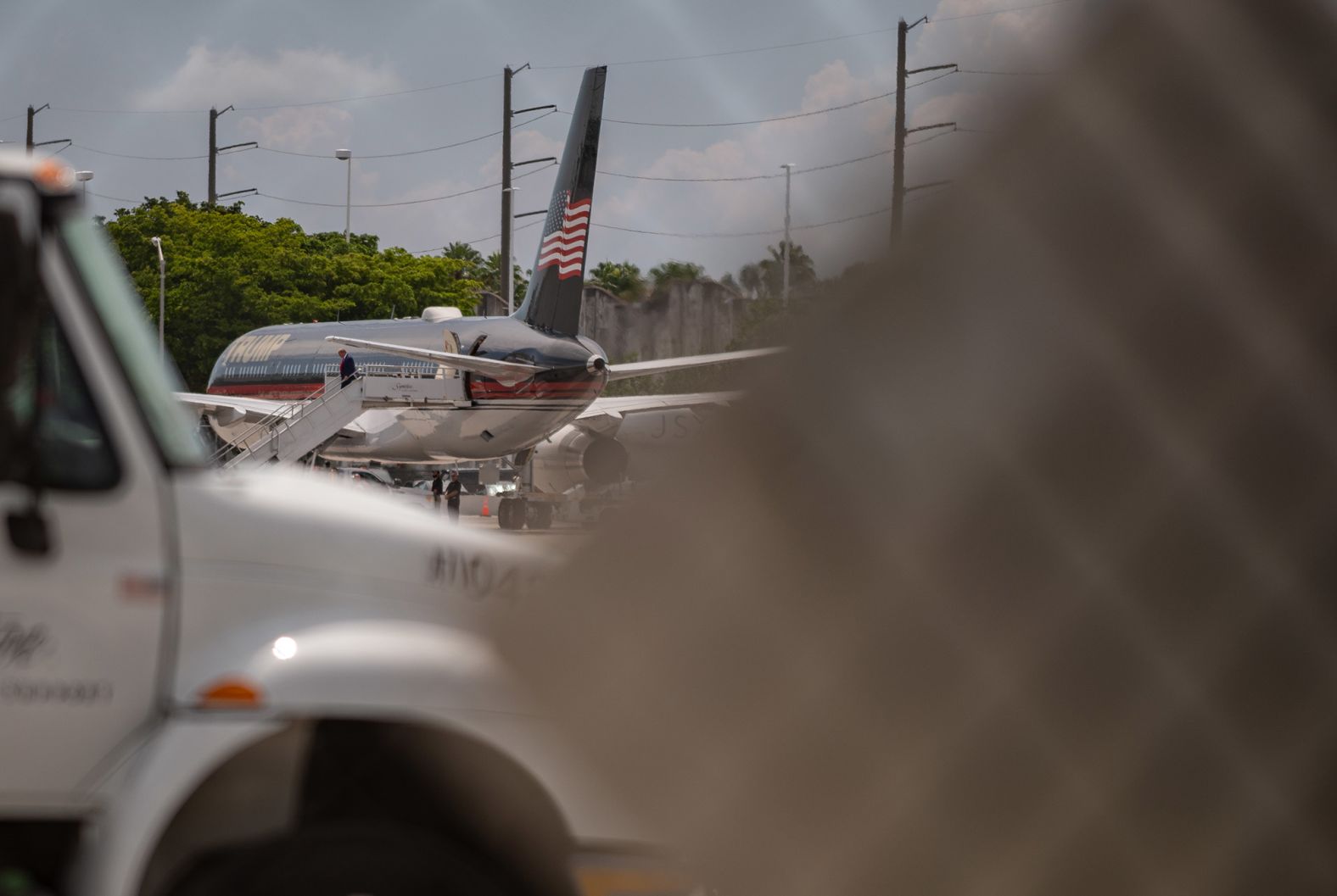 Trump walks off of his plane after landing at Miami International Airport.