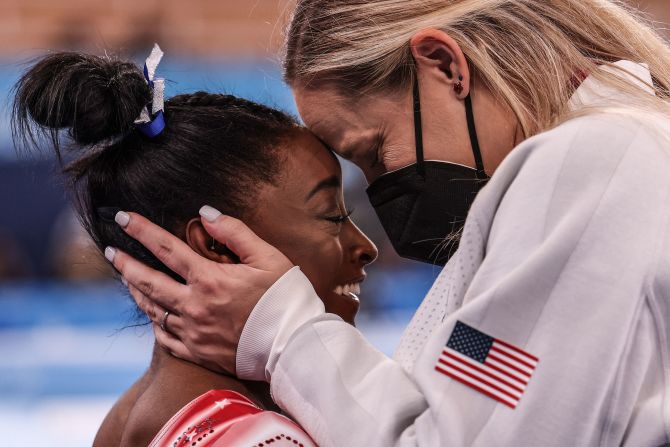 Biles is congratulated by coach Cecile Canqueteau-Landi after they realized Biles <a href="https://www.cnn.com/2021/08/03/sport/gallery/simone-biles-return-balance-beam/index.html" target="_blank">would win an Olympic bronze medal</a> in the balance beam final in July 2021. Biles had pulled out of several events earlier in Tokyo, citing mental health concerns. Specifically, she said she had "the twisties," a mental block in gymnastics in which competitors lose track of their positioning midair. Her bronze medal tied her with Shannon Miller for the most Olympic medals ever won by an American gymnast.