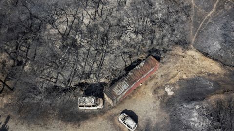 An aerial view shows burnt vehicles and trees after a fire near Vati, on the Greek Aegean island of Rhodes, on July 26, 2023. Wildfires have been raging in Greece amid scorching temperatures, forcing mass evacuations in several tourist spots including on the islands of Rhodes and Corfu. (Photo by Angelos Tzortzinis / AFP) (Photo by ANGELOS TZORTZINIS/AFP via Getty Images)