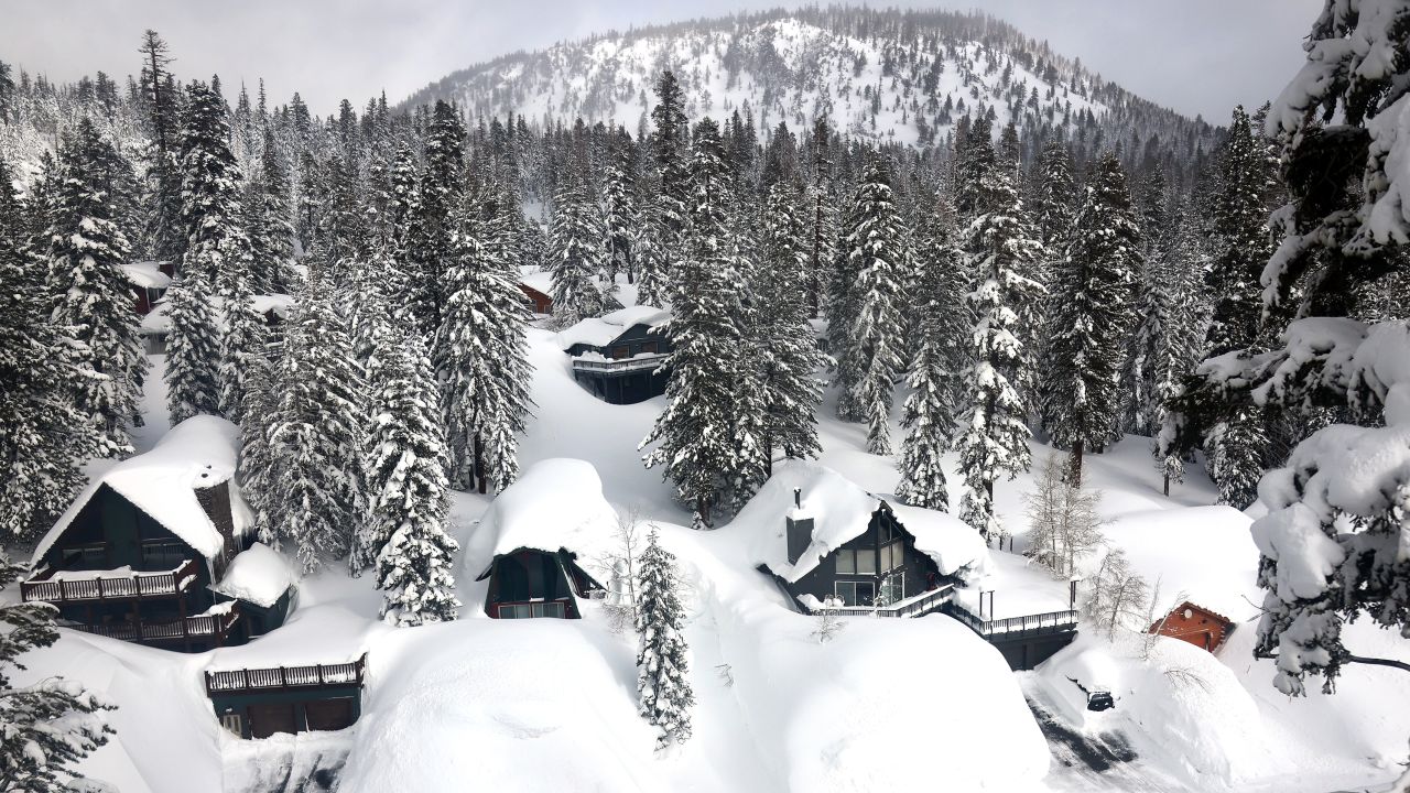 In an aerial view, a vehicle navigates a snowy roadway lined with snowbanks piled up from new and past storms in the Sierra Nevada mountains, in the wake of an atmospheric river event, on March 12, 2023 in Mammoth Lakes, California. Flooding washed away roads and breached a levee in parts of Northern and Central California due to runoff from the state's 10th atmospheric river storm. The eastern Sierra Nevada currently is holding 243 percent of its regular snowpack for this time of the year. California is bracing for another powerful atmospheric river event, bringing more snow to higher elevations and rain to lower elevations, beginning tomorrow.