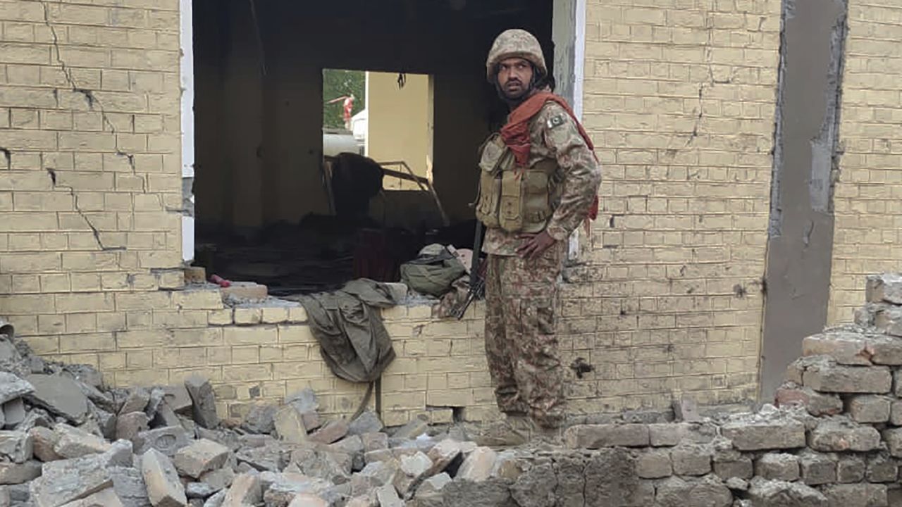 An army soldier examines damages on the site of a bombing at a police station on the outskirts of Dera Ismail Khan, Pakistan, Tuesday, Dec. 12, 2023. A suicide bomber detonated his explosive-laden vehicle at a police station's main gate in northwest Pakistan on Tuesday, killing several policemen and wounding more than dozen others, officials said. Some militants also opened fire and a shootout between them and security forces was still ongoing, police officer Kamal Khan said. (AP Photo)