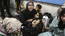 Wounded Palestinians sit in al-Shifa hospital in Gaza City, central Gaza Strip, after arriving from al-Ahli hospital following an explosion there, Tuesday, Oct. 17, 2023. The Hamas-run Health Ministry says an Israeli airstrike caused the explosion that killed hundreds at al-Ahli, but the Israeli military says it was a misfired Palestinian rocket. (AP Photo/Abed Khaled)